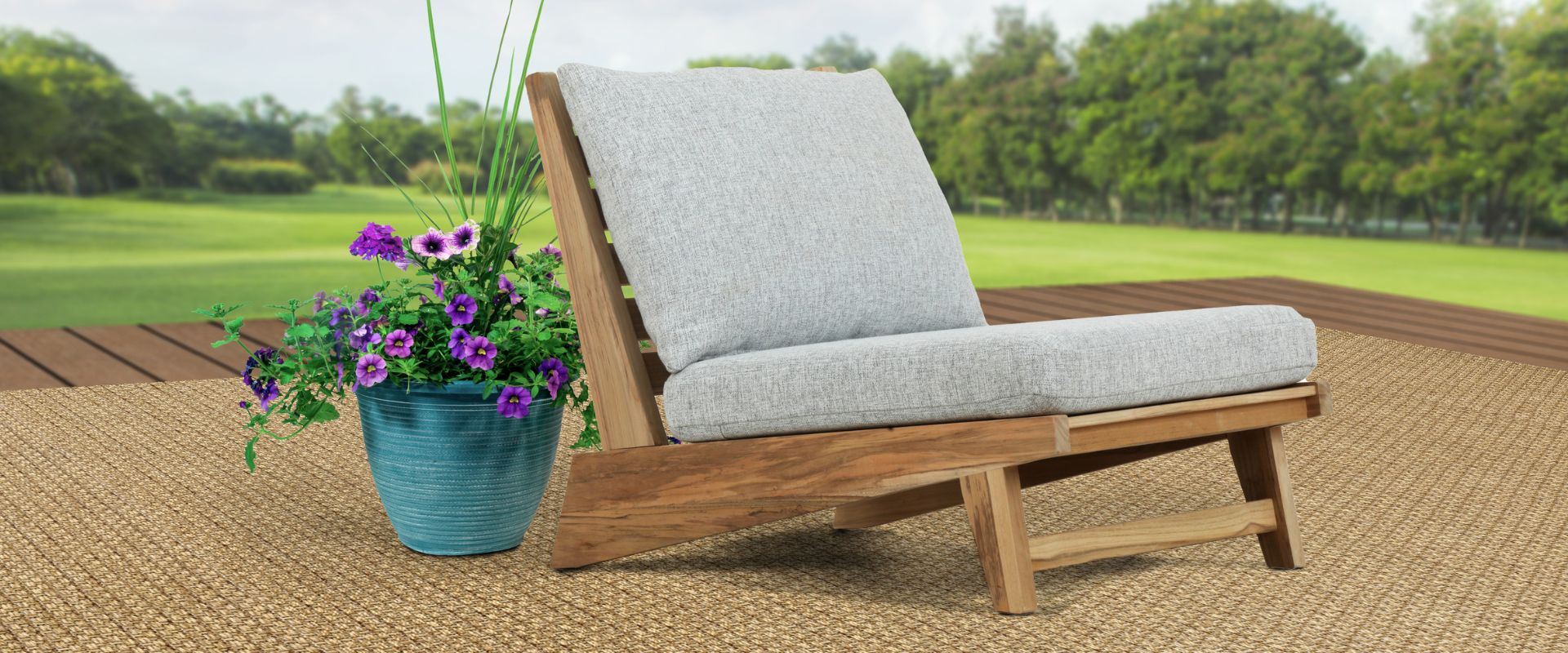 all weather outdoor beige rug with chair and purple flower plant.