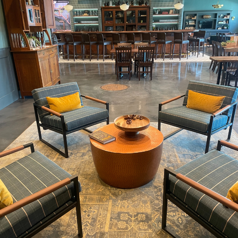 Multi colored area rug with four chairs.