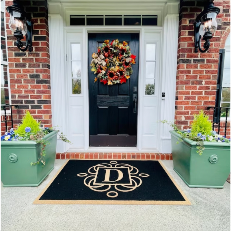 black doormat with the letter D.
