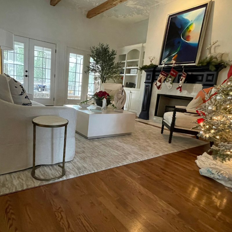 White area rug with christmas tree.