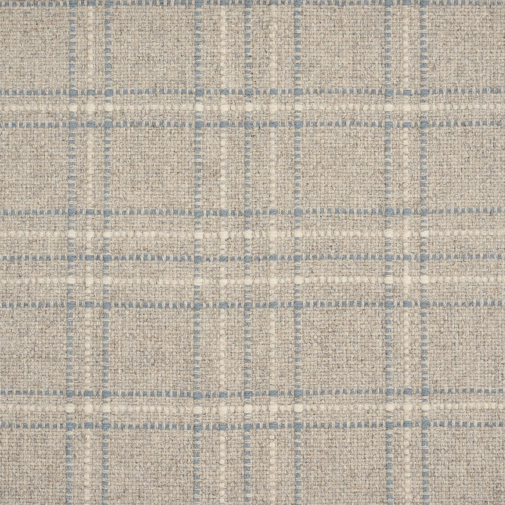 A close-up of a woven fabric with a textured plaid pattern in beige, cream, and muted blue-gray.