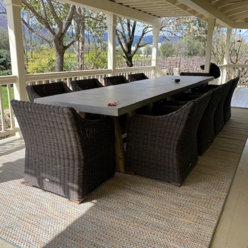 Outdoor area rug with large patio table.