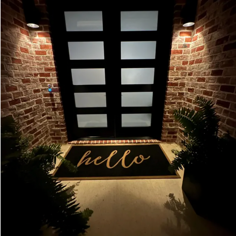 Black doormat that says 
