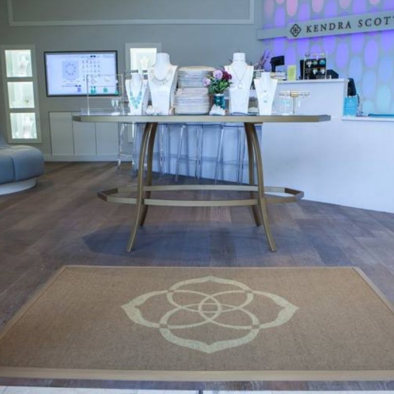 Custom logo mats at the entrance of a retail store - enhances branding and floor protection.